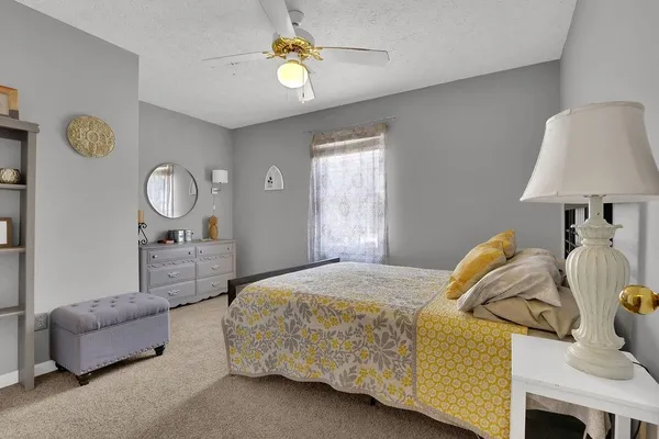 a bedroom with bed and a window