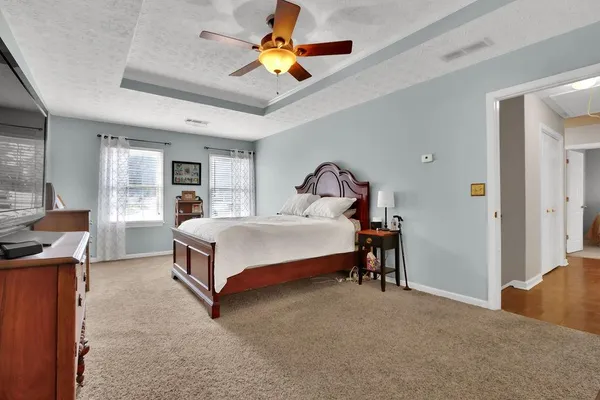 a bedroom with a bed and a chandelier