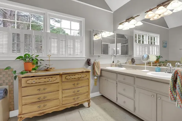 a bathroom with a sink double vanity and a mirror