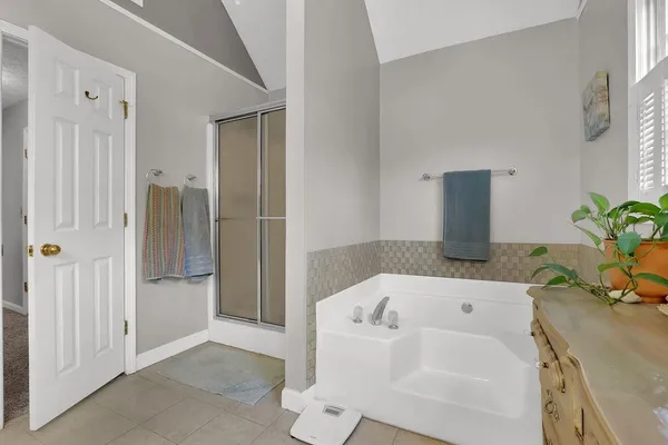 a bathroom with a tub and shower