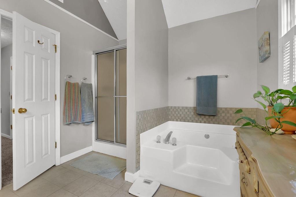 2385 Waterton Ridge Trail Grayson, GA 30017 - Photo 27 of 38 a bathroom with a tub and shower