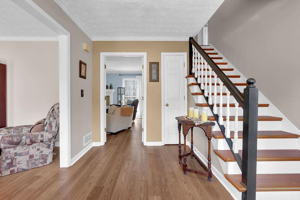 2385 Waterton Ridge Trail Grayson, GA 30017 - Photo 3 of 38 a living room with furniture and a wooden floor