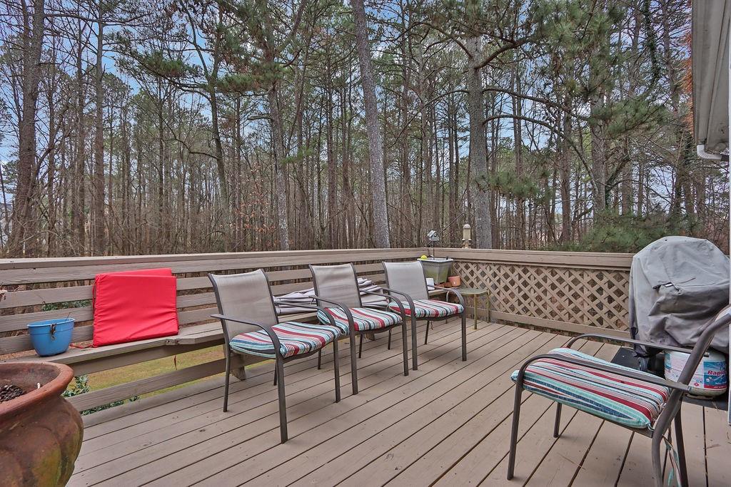 2385 Waterton Ridge Trail Grayson, GA 30017 - Photo 31 of 38 a patio of a house with wooden chairs and wooden fence