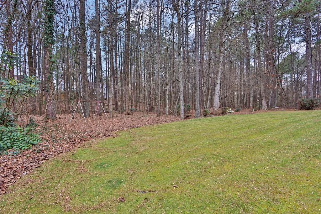 2385 Waterton Ridge Trail Grayson, GA 30017 - Photo 33 of 38 a view of a yard with large trees