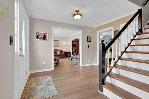 a view of an entryway with wooden floor and a rug
