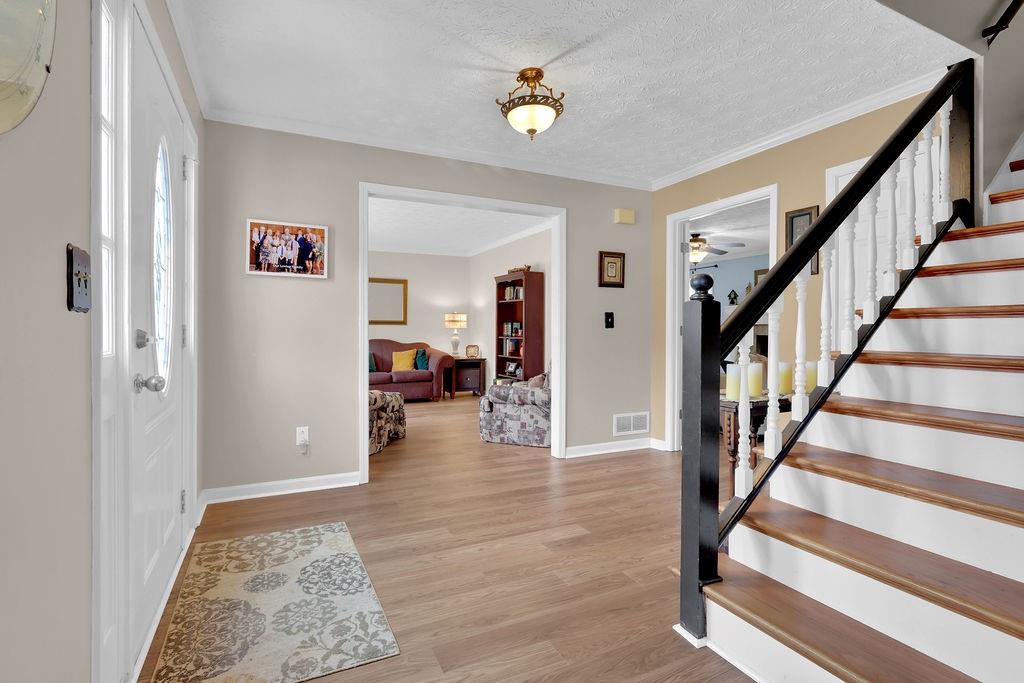 2385 Waterton Ridge Trail Grayson, GA 30017 - Photo 4 of 38 a view of an entryway with wooden floor and a rug