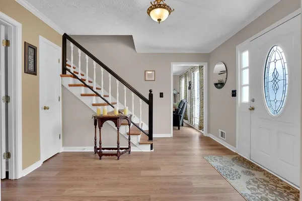 a view of an entryway with wooden floor