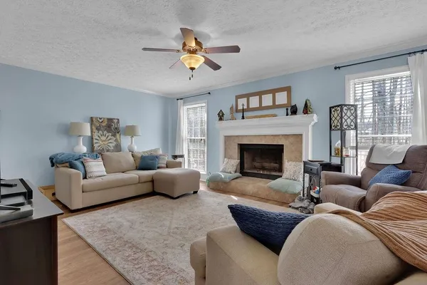 a living room with furniture and a fireplace