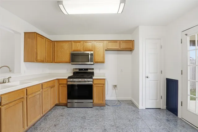 a kitchen with stainless steel appliances granite countertop a stove and a sink