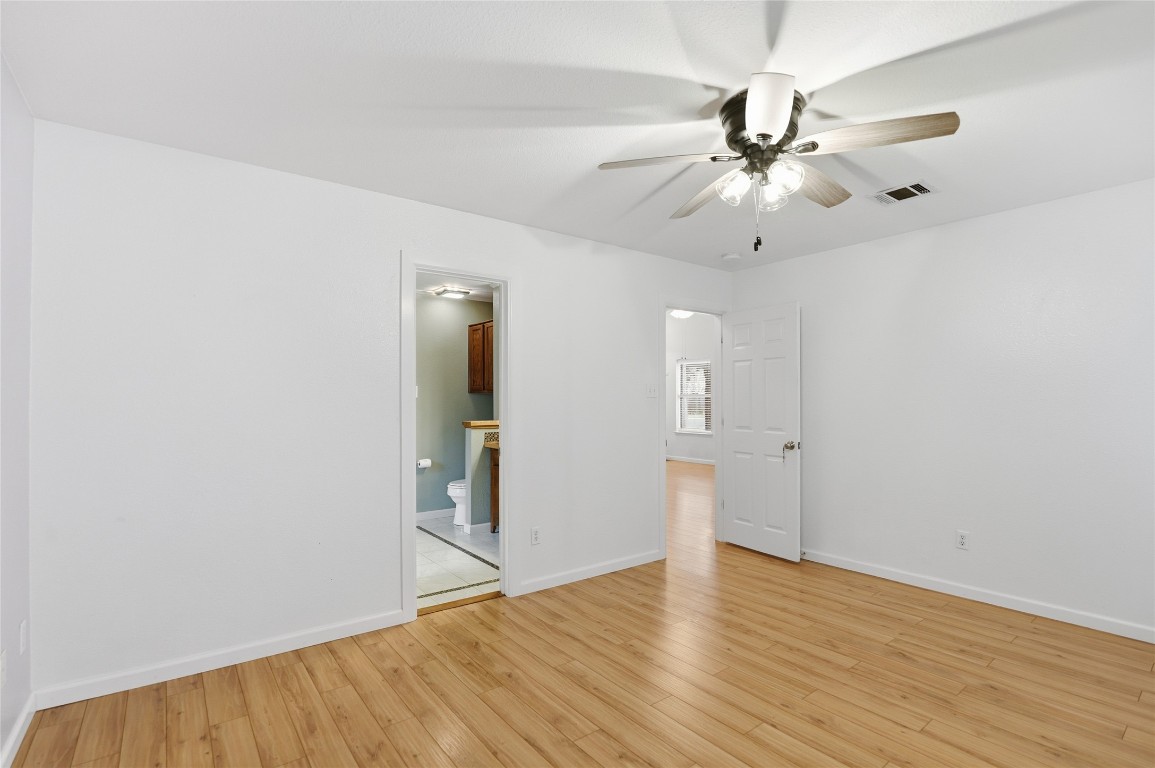 3215 Port Anne Way Leander, TX 78641 - Photo 16 of 30 an empty room with wooden floor fan and windows