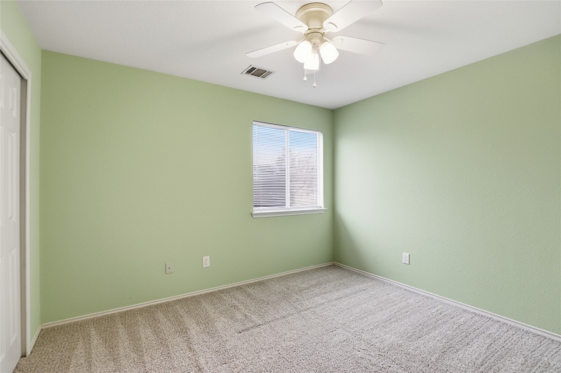 3215 Port Anne Way Leander, TX 78641 - Photo 20 of 30 an empty room with a window and a ceiling fan