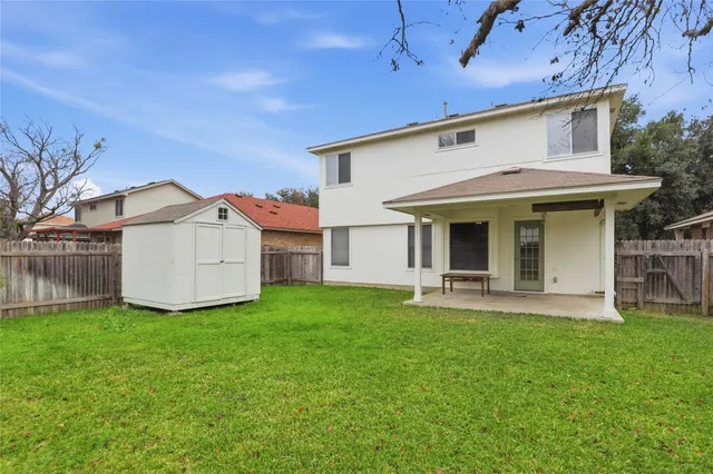 a view of a house with a yard and sitting area