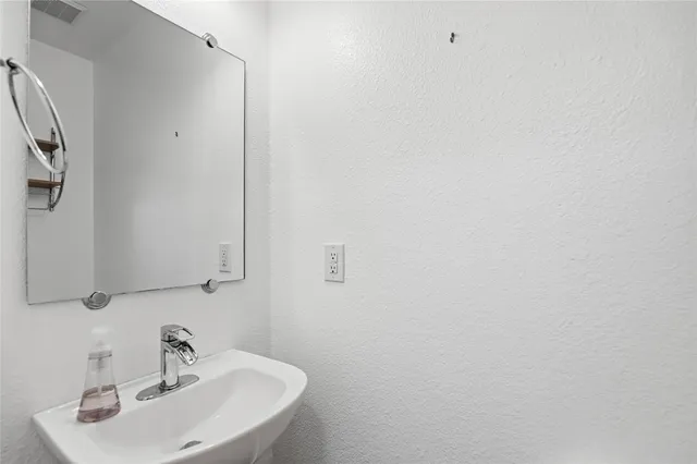 a bathroom with a sink and mirror