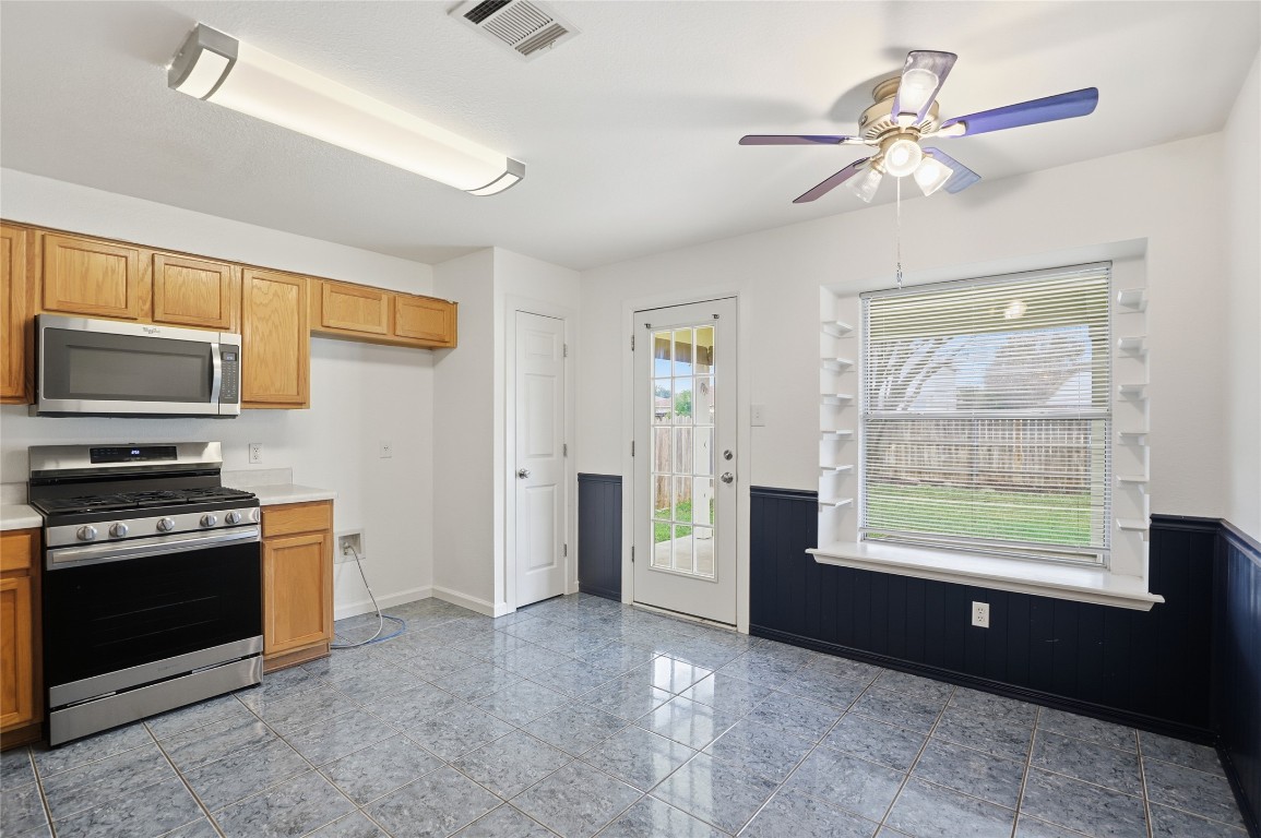 3215 Port Anne Way Leander, TX 78641 - Photo 8 of 30 a view of a kitchen with furniture a ceiling fan and window