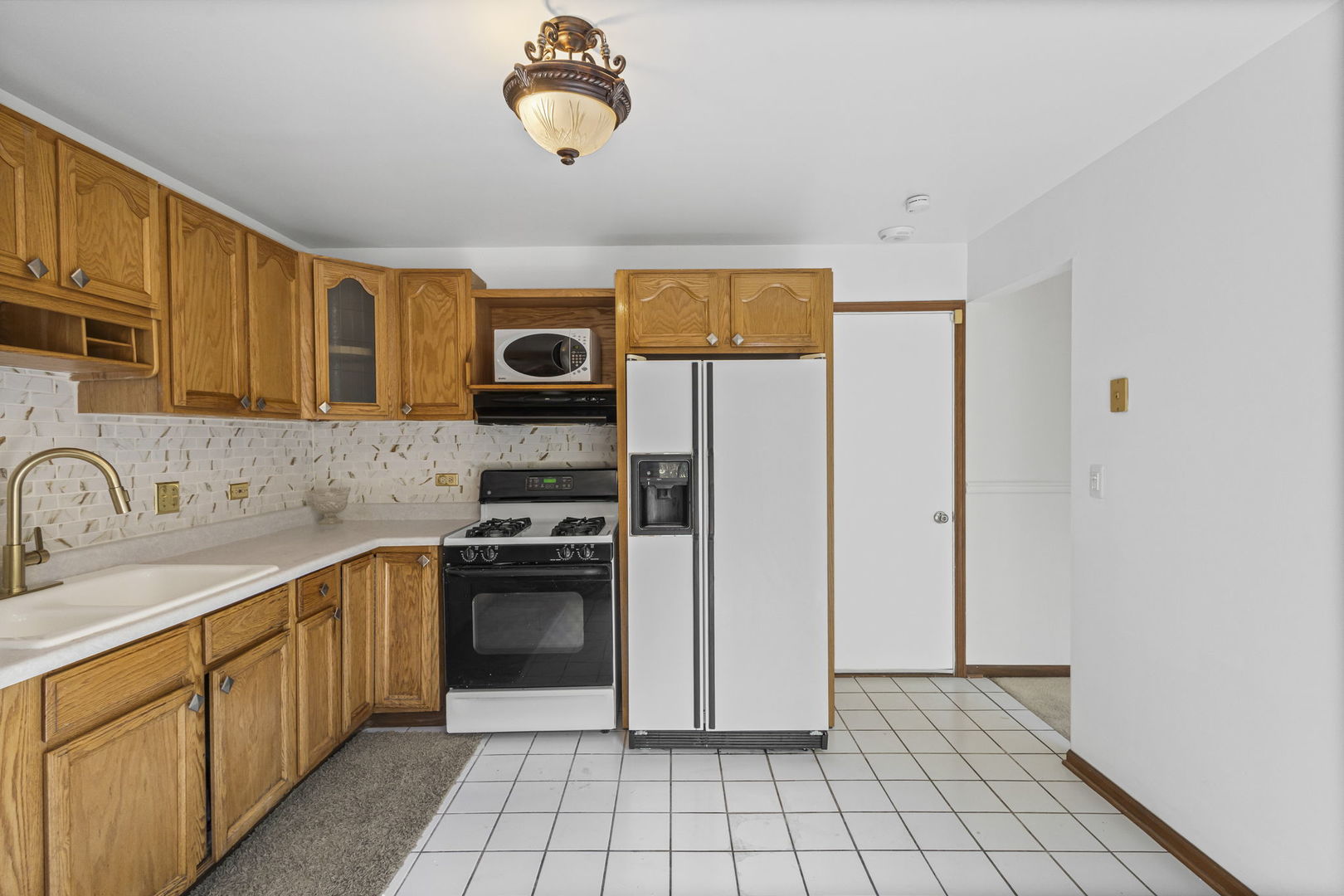 21220 Silktree Circle Plainfield, IL 60544 - Photo 6 of 29 a kitchen with stainless steel appliances granite countertop a stove a sink and a refrigerator