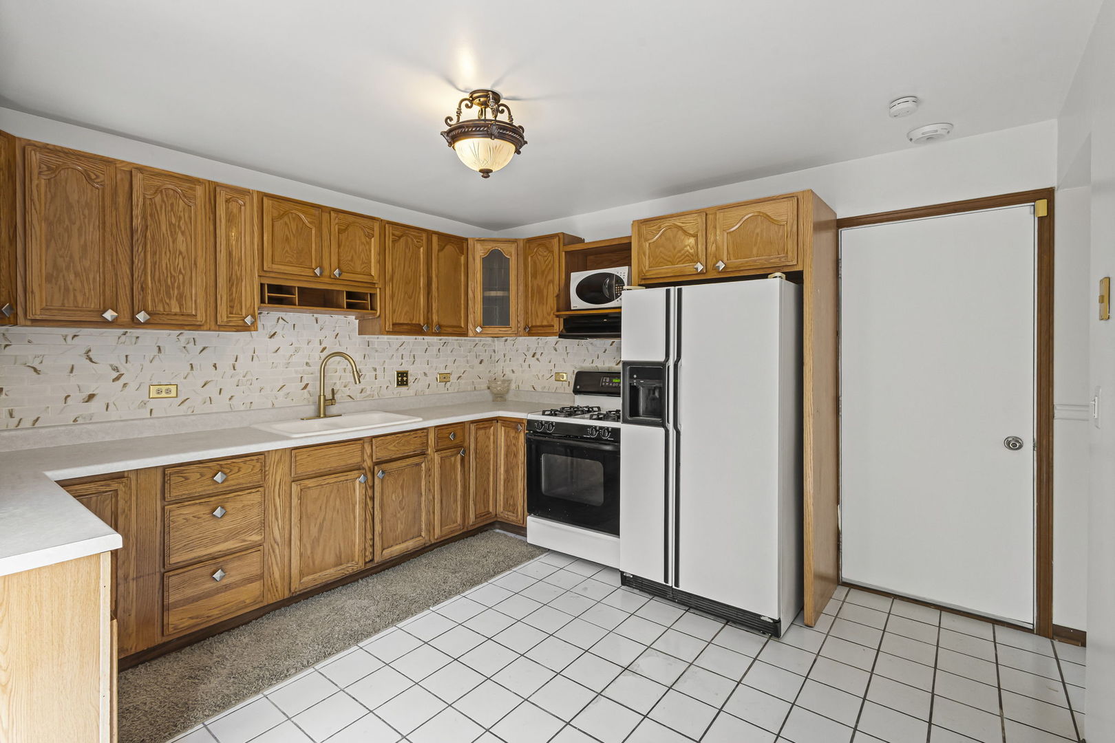 21220 Silktree Circle Plainfield, IL 60544 - Photo 7 of 29 a kitchen with a refrigerator sink and cabinets