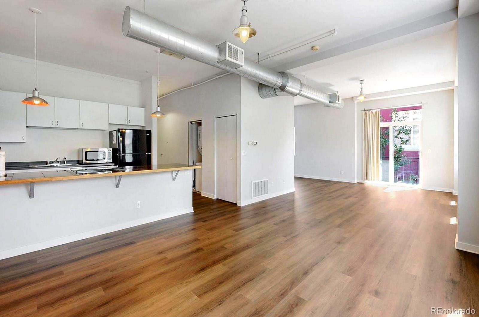 1521 Central Street, Unit 2D Denver, CO 80211 - Photo 4 of 35 a view of a kitchen with wooden floor and a sink