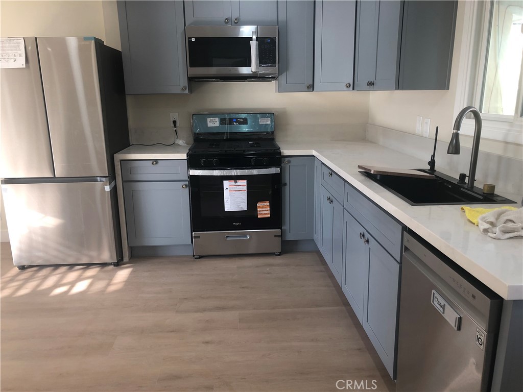 224 North Bircher Street Anaheim, CA 92801 - Photo 4 of 10 a kitchen with a refrigerator sink and microwave