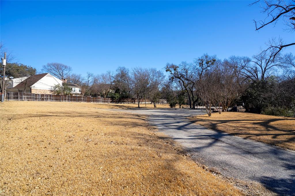 7121 Spring Valley Road Dallas, TX 75254 - Photo 1 of 1 a view of road with trees