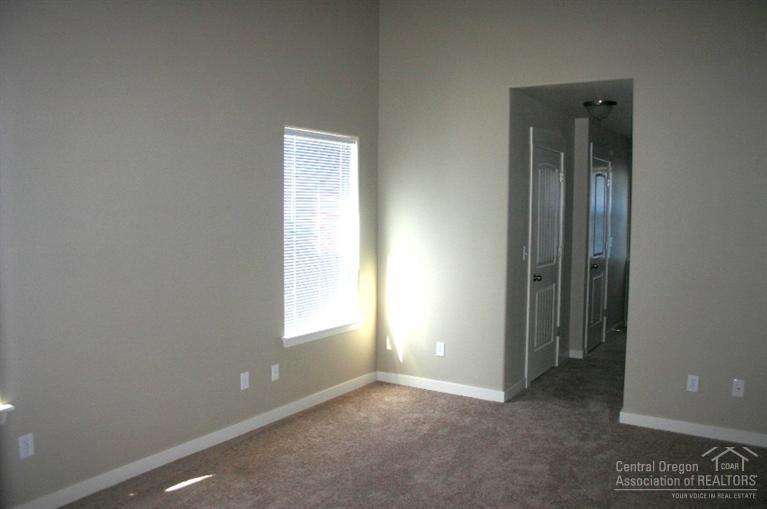 63201 Northeast Boyd Acres Road Bend, OR 97701 - Photo 6 of 14 an empty room with windows and closet