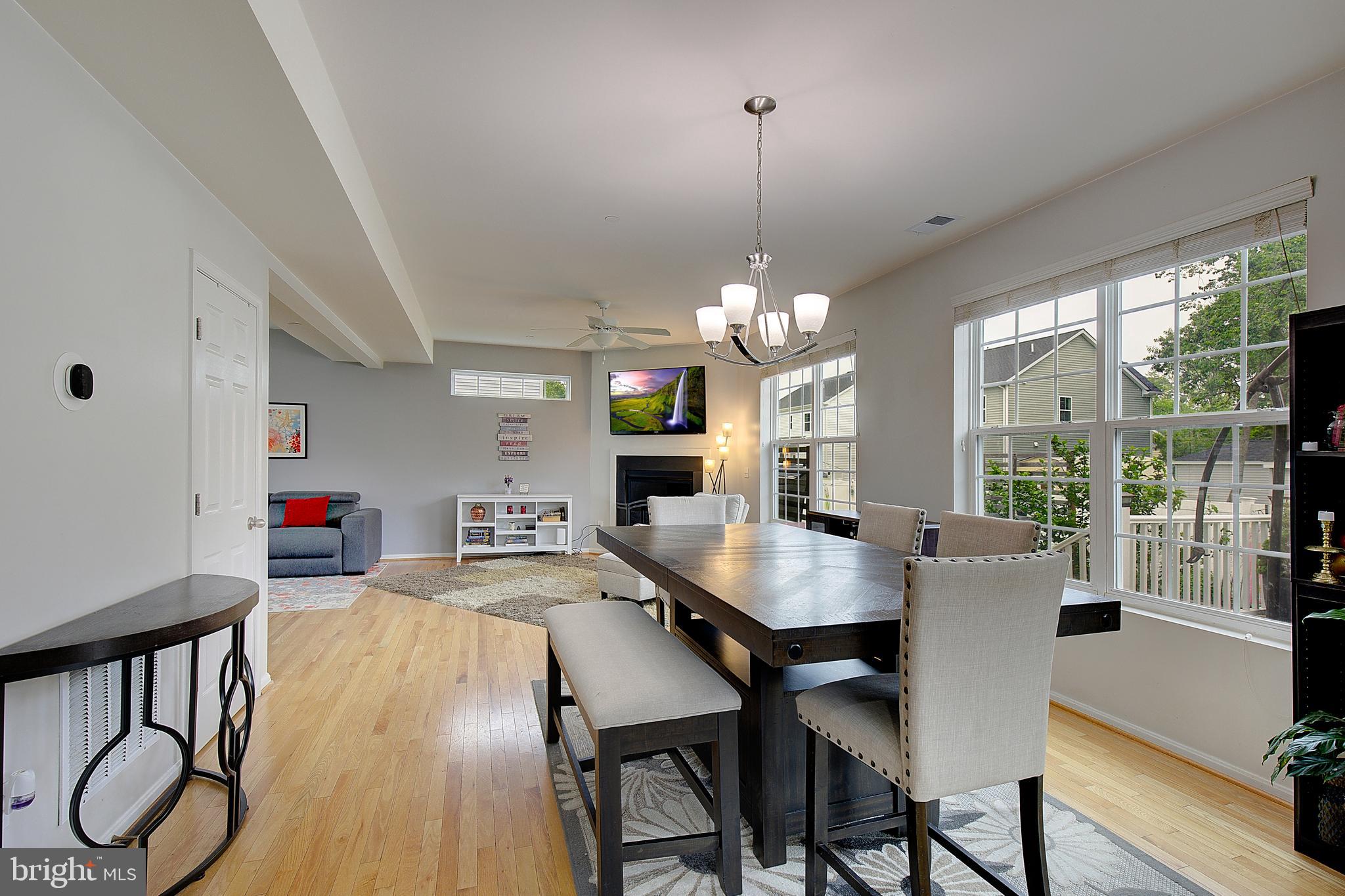 403 Venton Road Edgewater, MD 21037 - Photo 16 of 62 a view of a dining room and livingroom with furniture wooden floor a chandelier