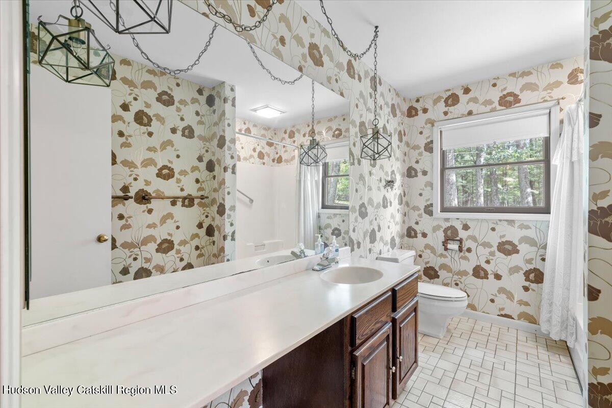 119 Mt Laurel Road Kerhonkson, NY 12446 - Photo 19 of 29 a bathroom with a sink a toilet and shower curtain
