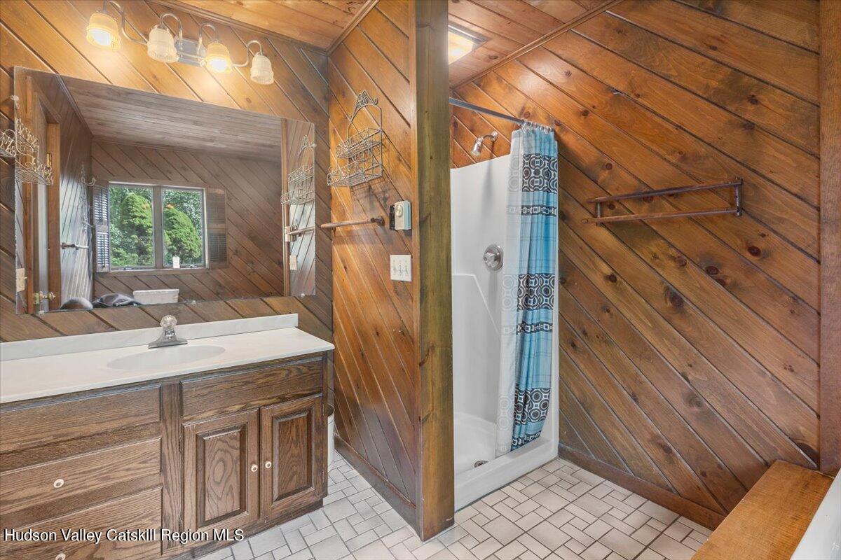 119 Mt Laurel Road Kerhonkson, NY 12446 - Photo 26 of 29 a bathroom with a sink and a mirror