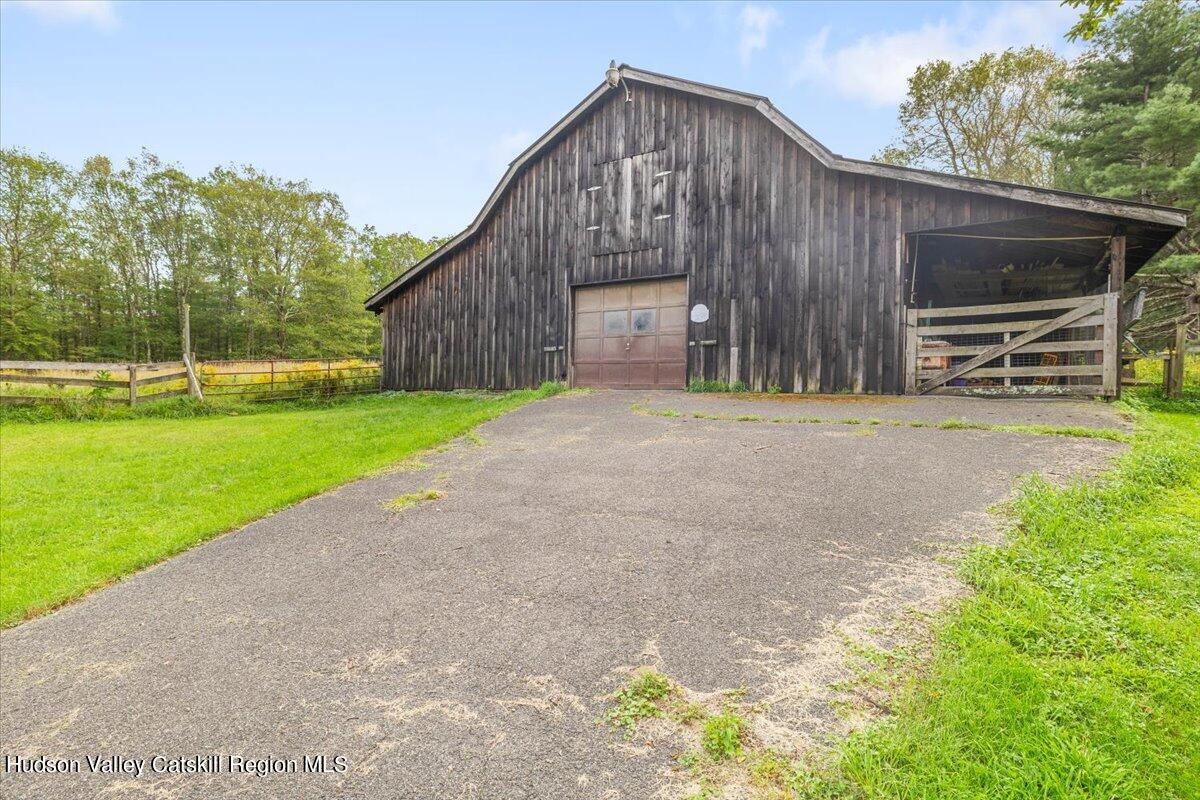 119 Mt Laurel Road Kerhonkson, NY 12446 - Photo 6 of 29 a front view of a house with a yard and a garage