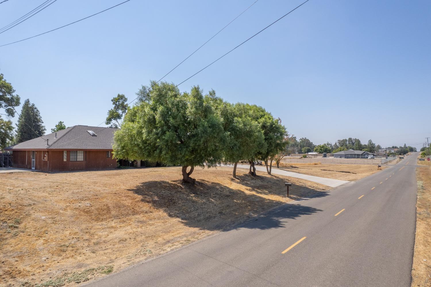 35516 John Albert Drive Madera, CA 93636 - Photo 46 of 60 a backyard of a house with yard and outdoor seating