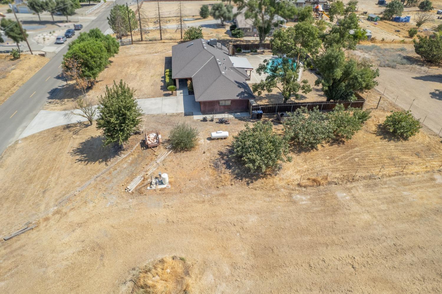 35516 John Albert Drive Madera, CA 93636 - Photo 54 of 60 an aerial view of a house with a yard and mountain view in back