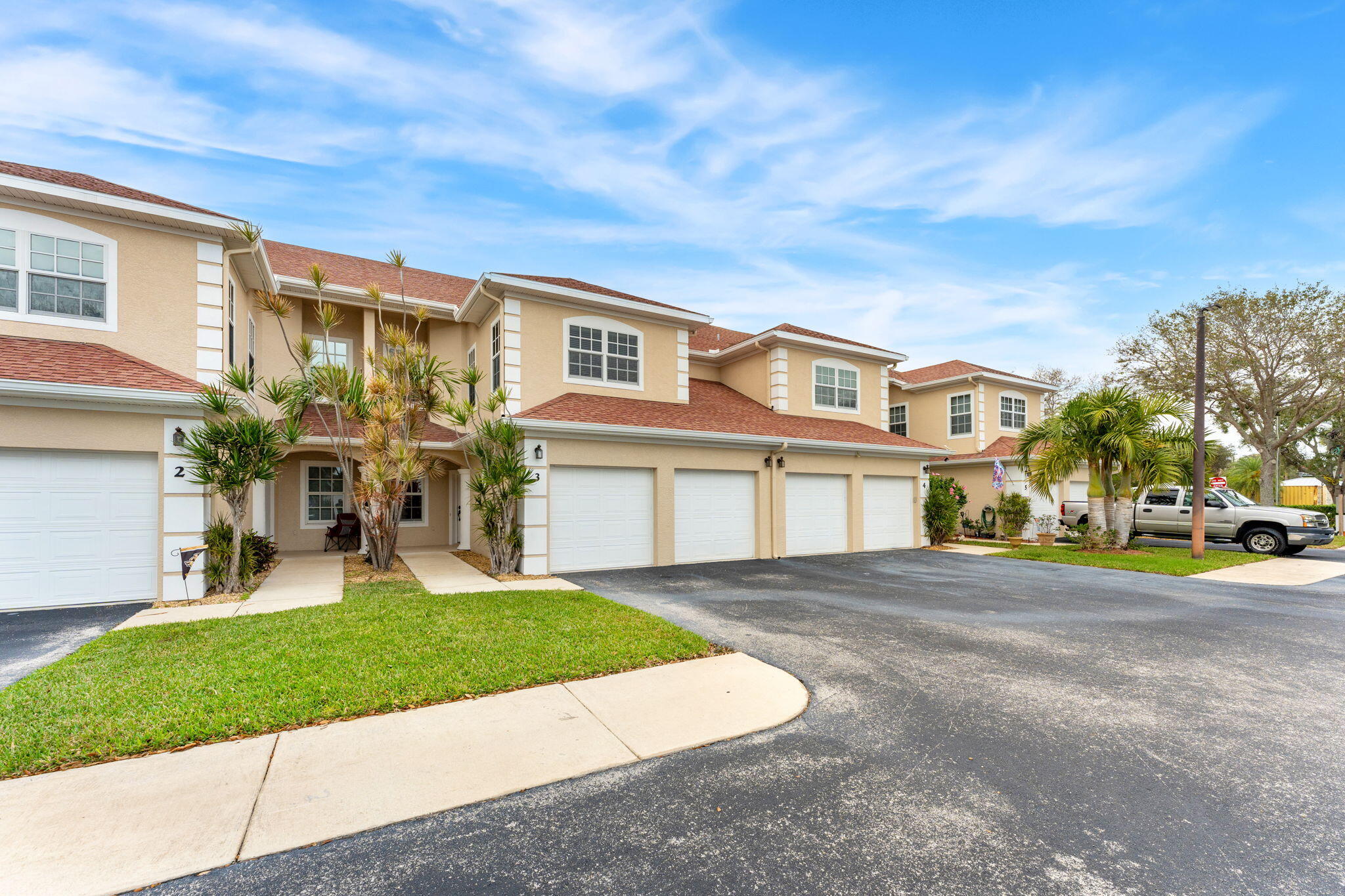 204 Holman Road, Unit 3 Cape Canaveral, FL 32920 - Photo 1 of 61 a front view of a house with a yard and potted plants