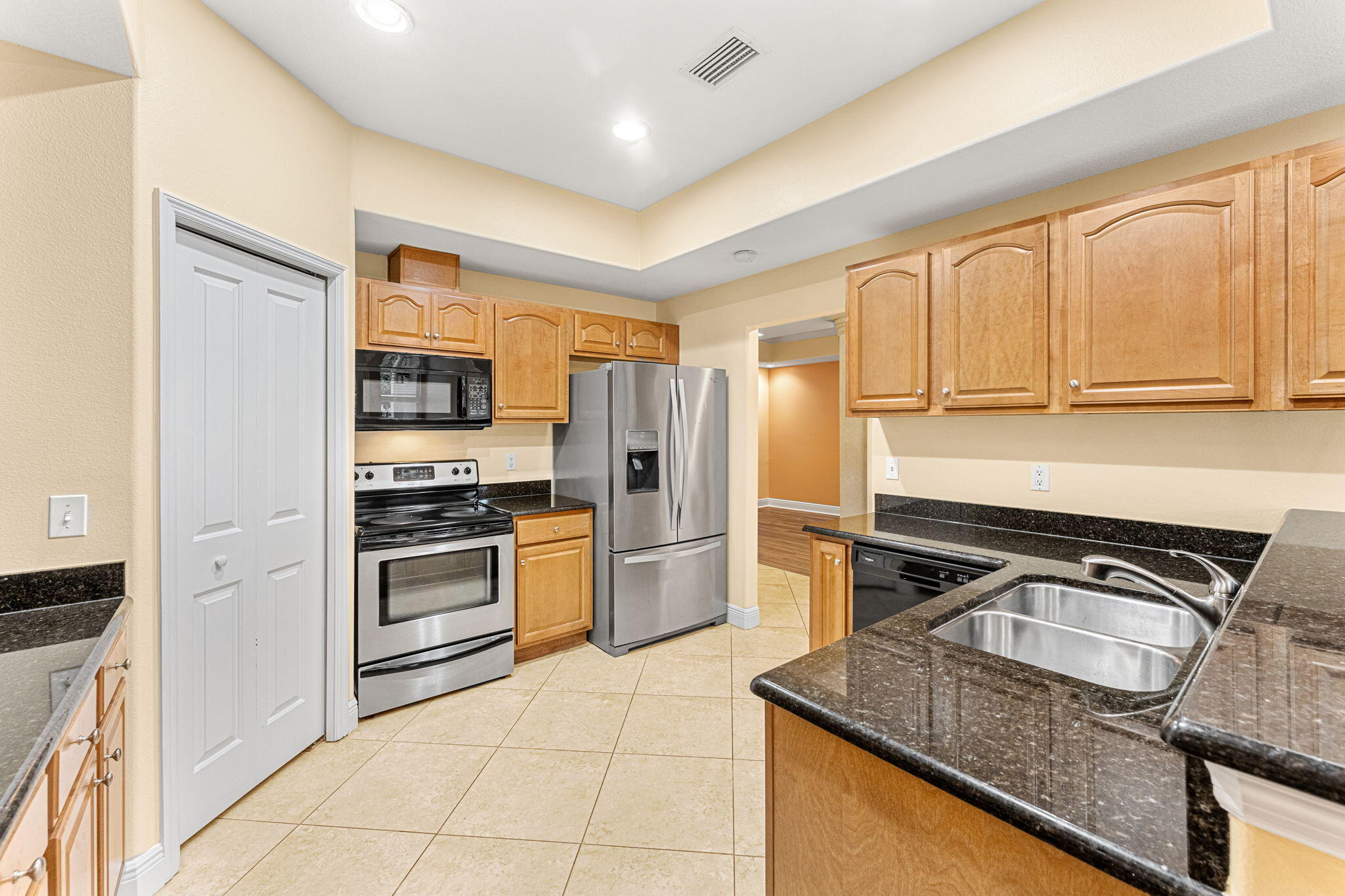 204 Holman Road, Unit 3 Cape Canaveral, FL 32920 - Photo 18 of 61 a kitchen with a stove sink and refrigerator