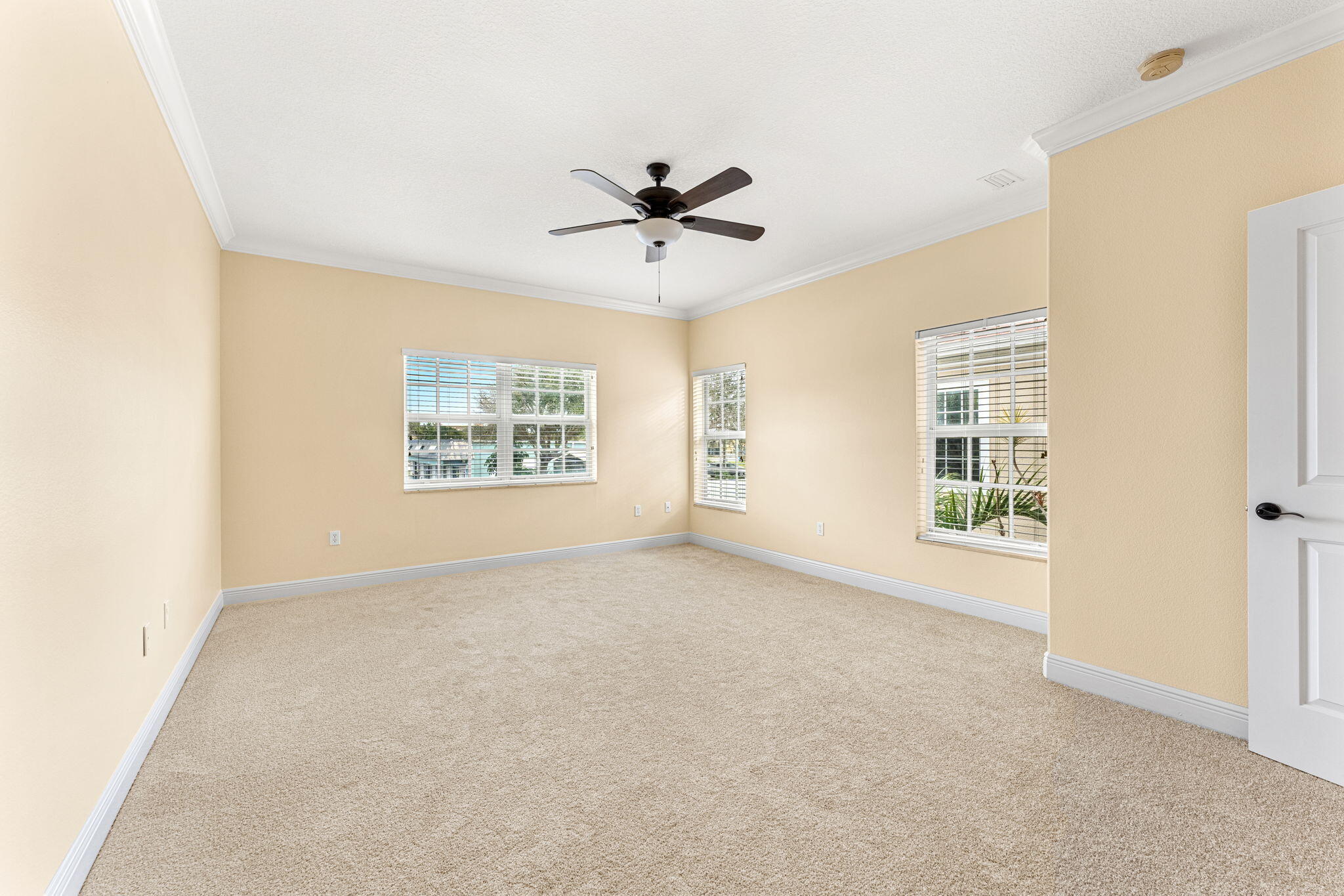 204 Holman Road, Unit 3 Cape Canaveral, FL 32920 - Photo 34 of 61 an empty room with windows and fan