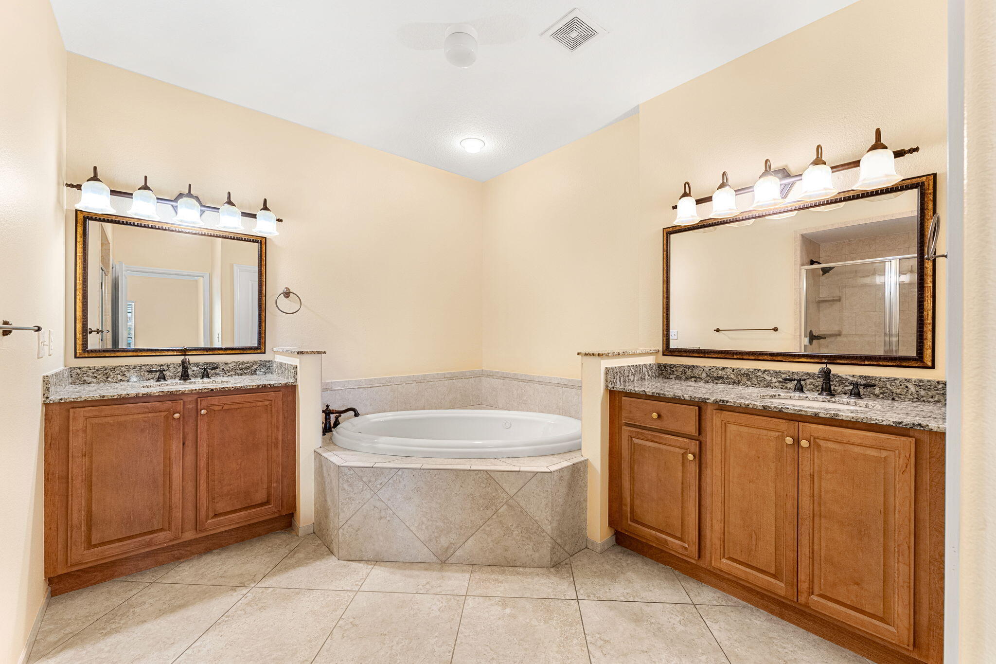 204 Holman Road, Unit 3 Cape Canaveral, FL 32920 - Photo 36 of 61 a bathroom with a tub a double vanity sink and a mirror