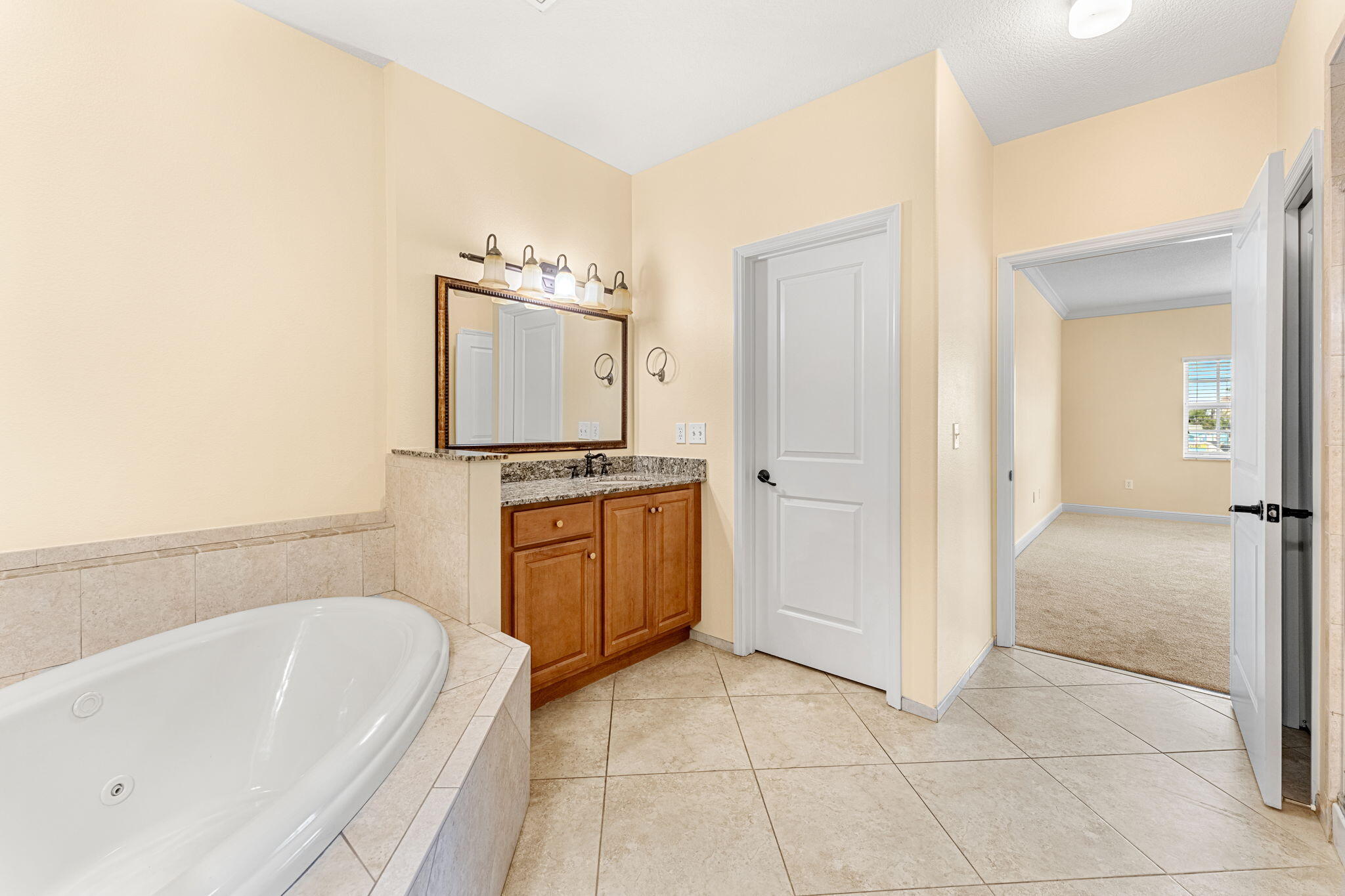 204 Holman Road, Unit 3 Cape Canaveral, FL 32920 - Photo 37 of 61 a bathroom with a tub a sink and a shower