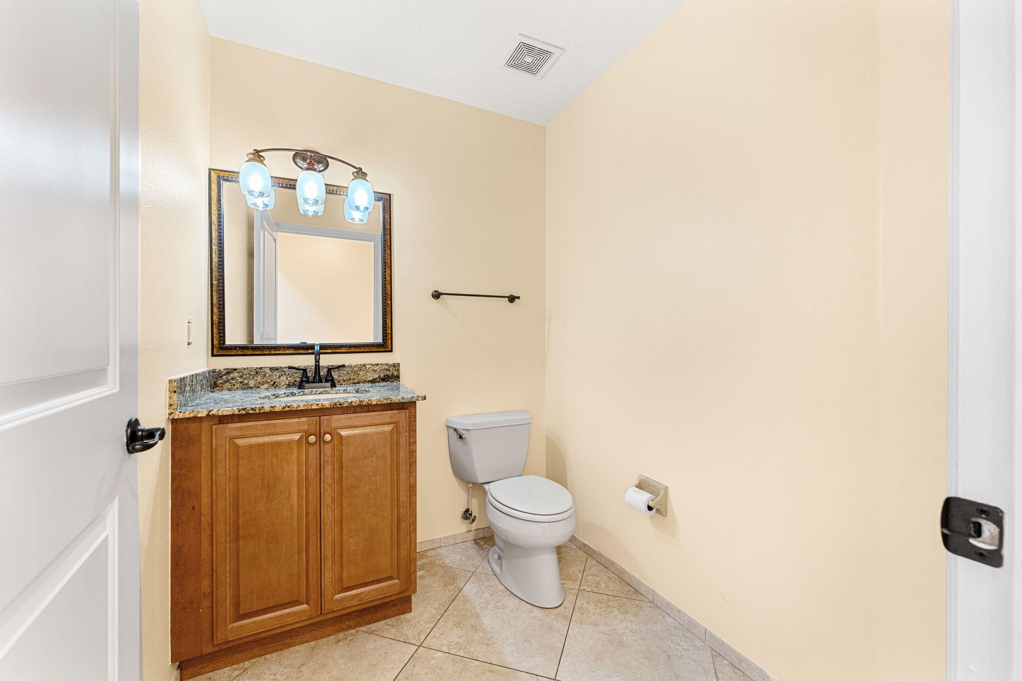 204 Holman Road, Unit 3 Cape Canaveral, FL 32920 - Photo 61 of 61 a bathroom with a granite countertop toilet and a sink