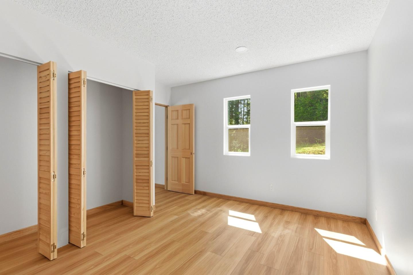 1460 Tucker Road Scotts Valley, CA 95066 - Photo 17 of 32 an empty room with wooden floor and windows