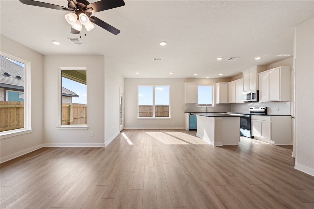 2415 Rooke Road Bryan, TX 77807 - Photo 13 of 36 a view of an empty room with a kitchen and window