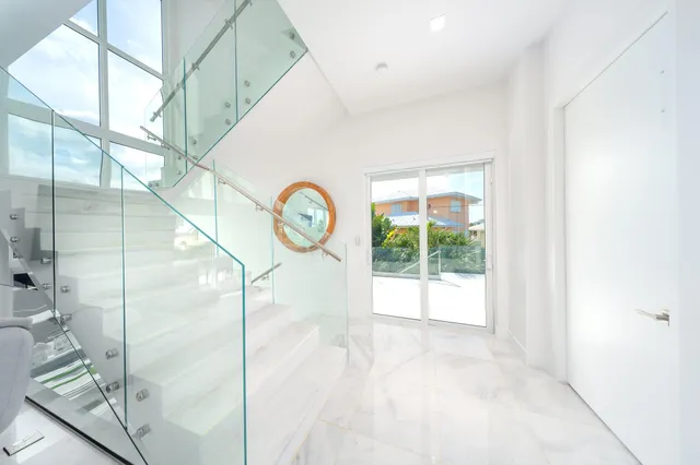 a living room with furniture kitchen view and large windows