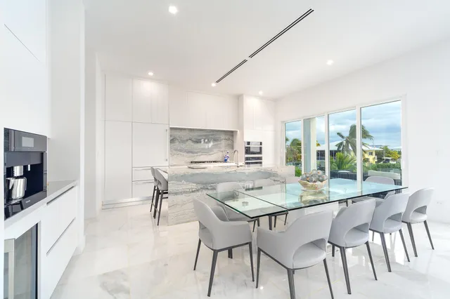 a kitchen with stainless steel appliances kitchen island granite countertop a sink and cabinets