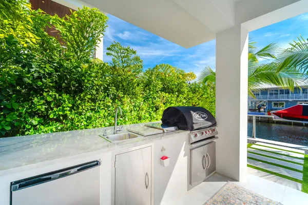 a kitchen with stainless steel appliances kitchen island granite countertop a sink and cabinets