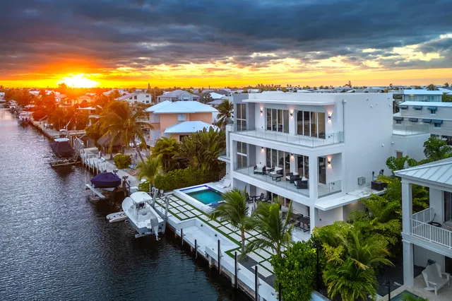 a view of a house with pool and chairs