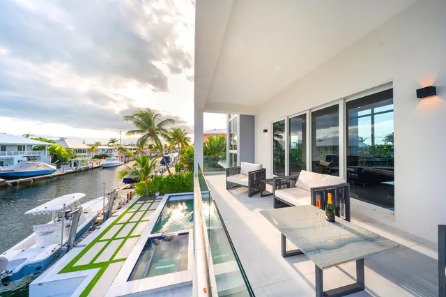 a bedroom with a bed and large windows