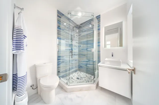 an aerial view of residential houses with outdoor space and swimming pool