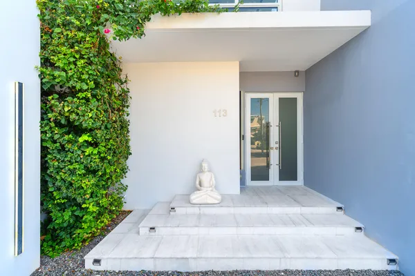 a bedroom with furniture and a large window