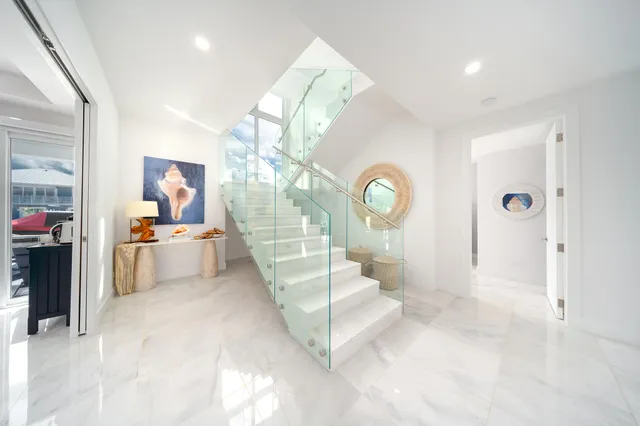 a living room with furniture a fireplace and a floor to ceiling window