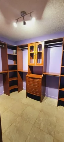 a room with furniture and a ceiling fan