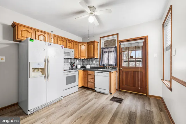 a kitchen with stainless steel appliances a refrigerator and a stove top oven