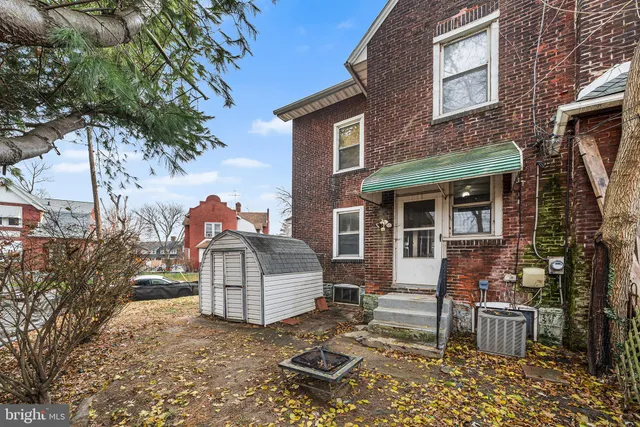a backyard of a house with yard fire pit and outdoor seating