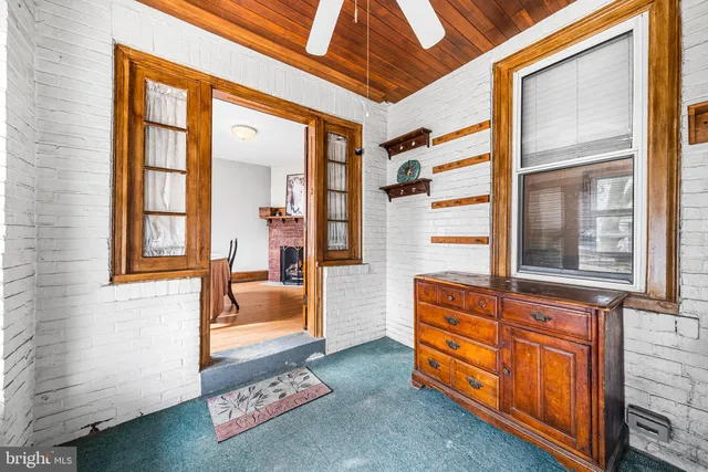 a living room with furniture and next to a window